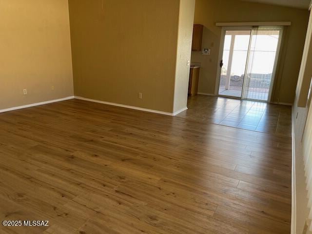 spare room featuring dark hardwood / wood-style floors