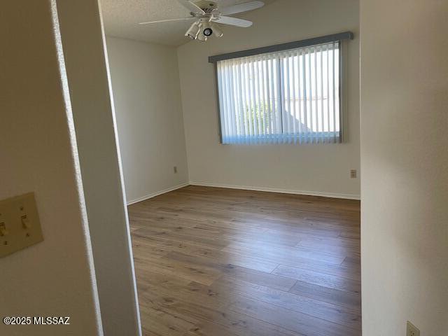 spare room featuring ceiling fan, a textured ceiling, and hardwood / wood-style flooring