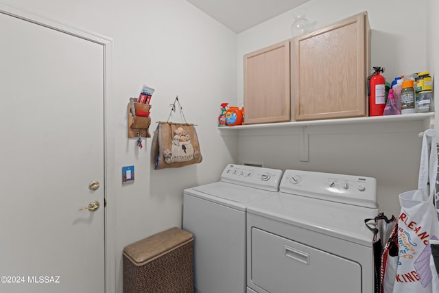 laundry area featuring cabinet space and washing machine and clothes dryer