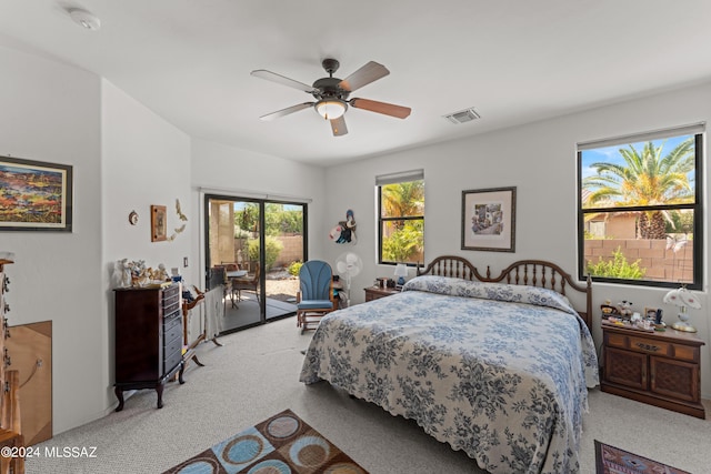 bedroom featuring access to outside, visible vents, a ceiling fan, and light colored carpet