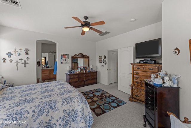 bedroom featuring arched walkways, carpet flooring, visible vents, and a ceiling fan