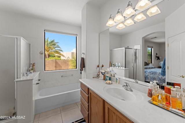 ensuite bathroom with a garden tub, connected bathroom, a shower stall, vanity, and tile patterned flooring