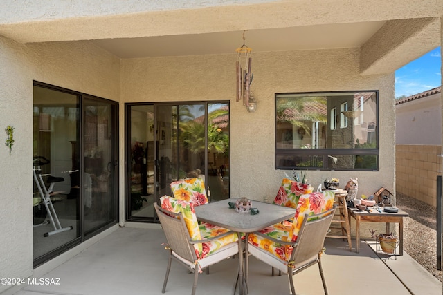 view of patio with outdoor dining area and fence