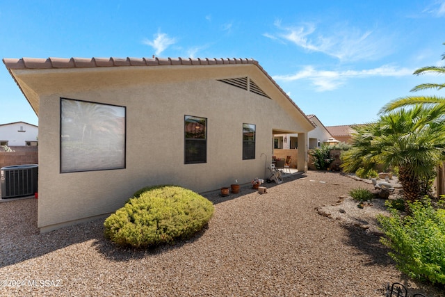 back of property with a patio, fence, cooling unit, and stucco siding