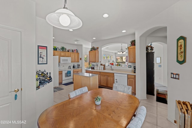 dining space with recessed lighting, arched walkways, and light tile patterned floors