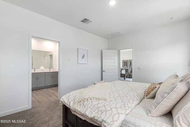 bedroom with carpet and ensuite bath