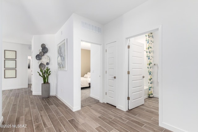 corridor with hardwood / wood-style floors