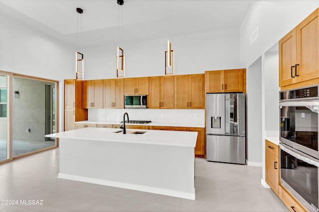 14821 E Diamond F Rnch Pl, Vail, AZ 85641 - kitchen featuring light tile patterned floors, stainless steel appliances, a center island with sink, a towering ceiling, and light countertops