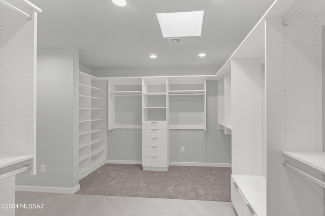 14821 E Diamond F Rnch Pl, Vail, AZ 85641 - walk in closet featuring light carpet, light tile patterned flooring, visible vents, and a skylight