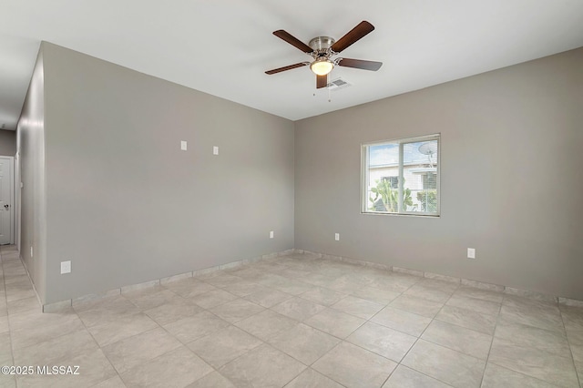 tiled empty room with ceiling fan