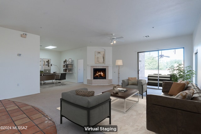 carpeted living room with ceiling fan