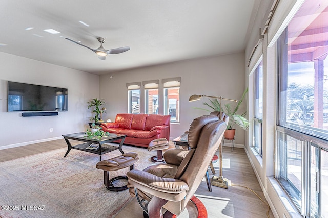 living room featuring light wood-type flooring and ceiling fan