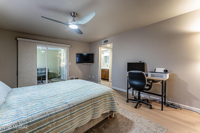 bedroom featuring hardwood / wood-style floors, ceiling fan, access to outside, and connected bathroom