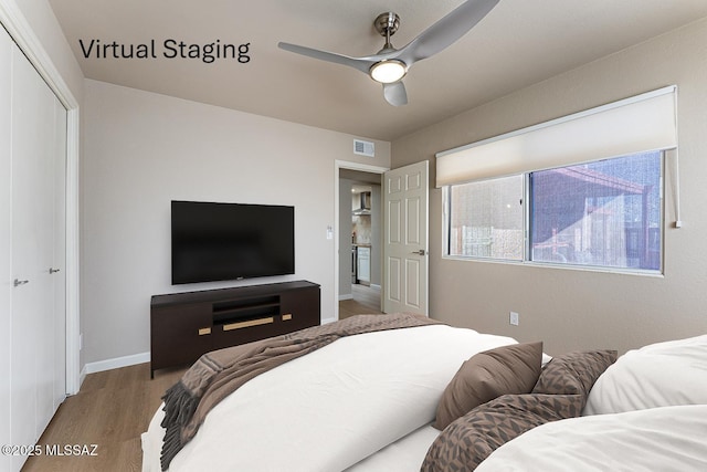 bedroom with a closet, ceiling fan, and hardwood / wood-style floors