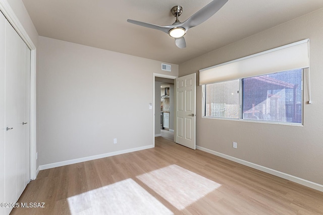 unfurnished bedroom featuring a closet, ceiling fan, and light hardwood / wood-style flooring