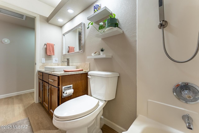 bathroom featuring wood-type flooring, vanity, and toilet