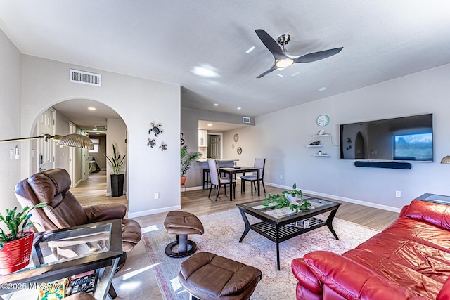 living room with hardwood / wood-style floors and ceiling fan