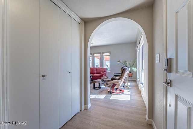 corridor with light hardwood / wood-style flooring