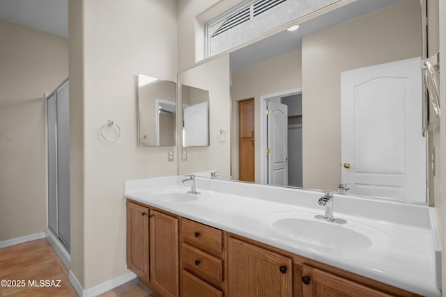 bathroom featuring vanity, tile patterned floors, and a shower with shower door