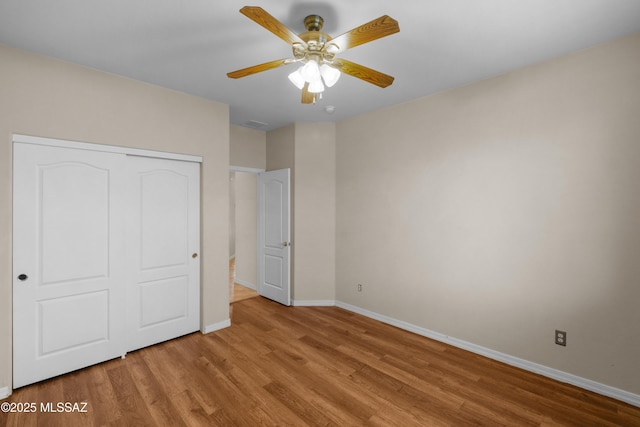 unfurnished bedroom with a closet, ceiling fan, and light hardwood / wood-style flooring