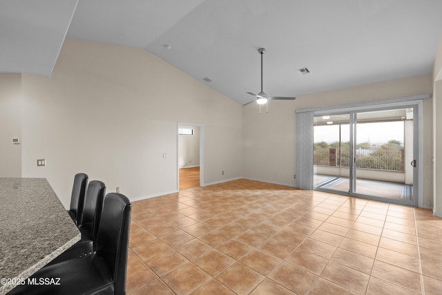 interior space featuring vaulted ceiling, ceiling fan, and light tile patterned flooring