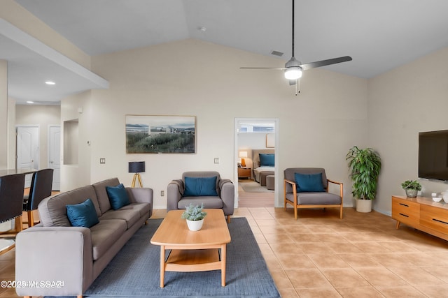 living room featuring ceiling fan, vaulted ceiling, and light tile patterned floors