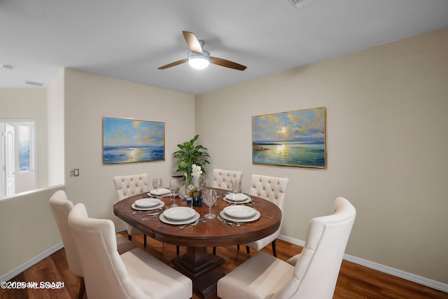 dining space with ceiling fan and dark hardwood / wood-style floors