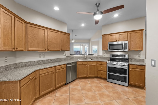 kitchen featuring stainless steel appliances, light stone countertops, light tile patterned floors, ceiling fan, and sink