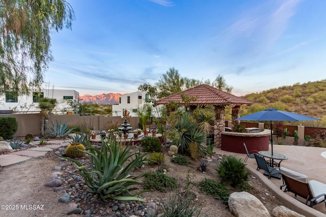 view of yard featuring a mountain view, a gazebo, and a patio