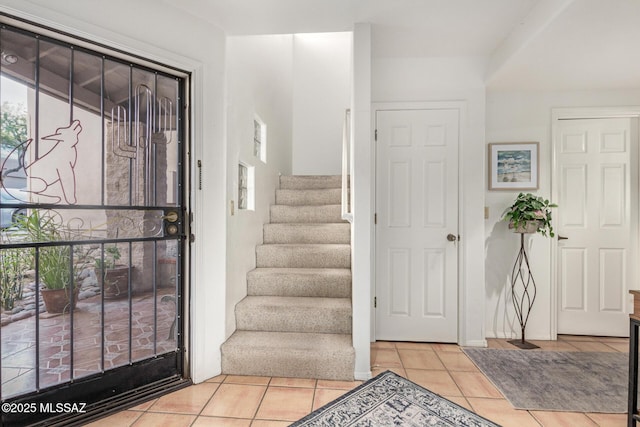 foyer entrance with light tile patterned flooring