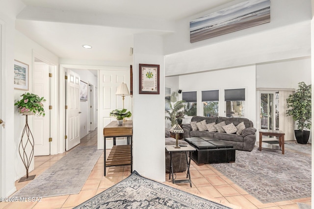 living area with recessed lighting and light tile patterned flooring