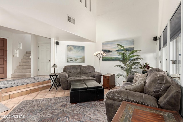 tiled living room with a high ceiling