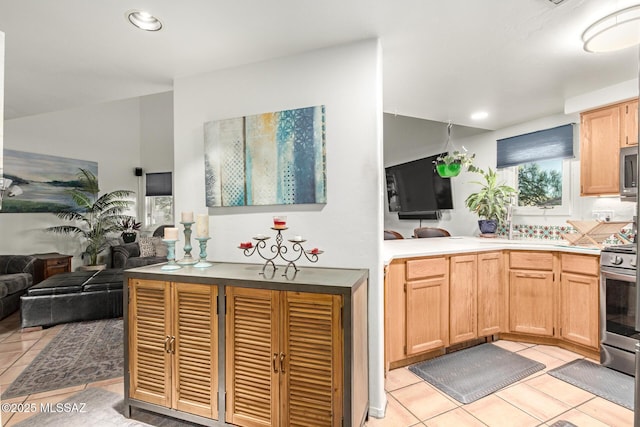 kitchen with stainless steel appliances, recessed lighting, open floor plan, and light tile patterned floors