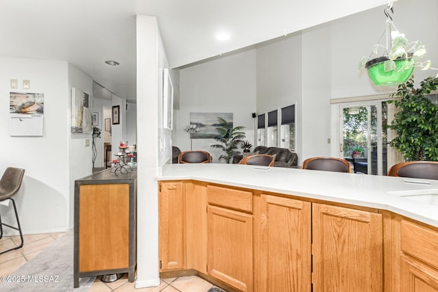 kitchen with light tile patterned floors and kitchen peninsula