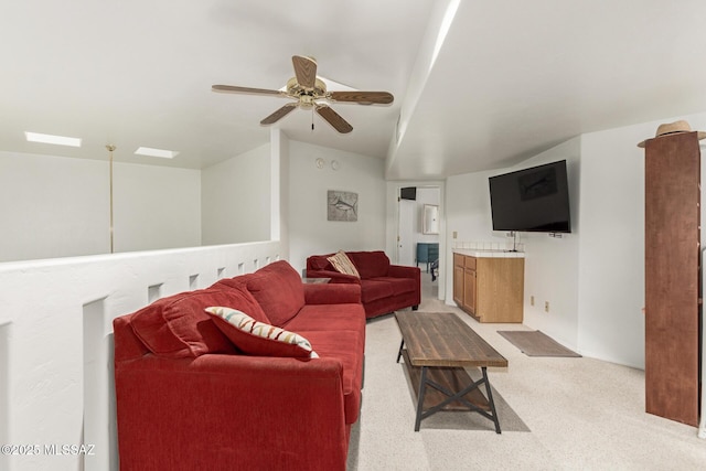 carpeted living room with vaulted ceiling and ceiling fan