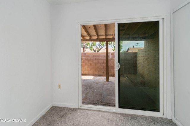 doorway to outside with carpet flooring