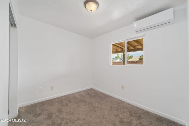 carpeted spare room with a wall mounted AC