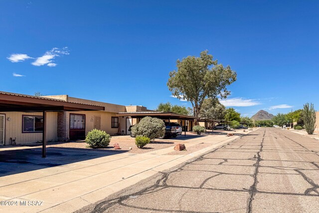 view of front of home with a mountain view and a carport