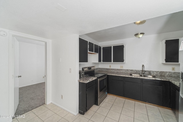 kitchen featuring light tile patterned floors, stainless steel range with electric cooktop, and sink