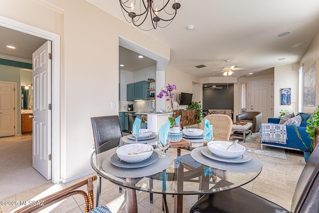 dining space featuring light tile patterned floors and ceiling fan with notable chandelier