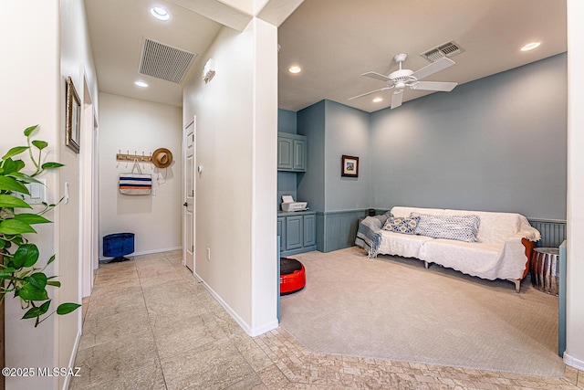 sitting room with ceiling fan and light colored carpet