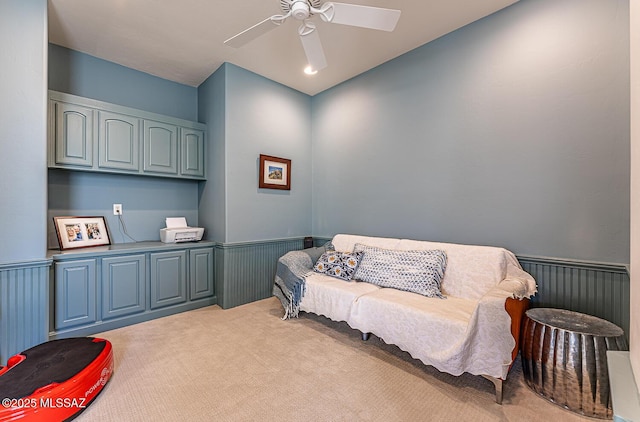 sitting room with ceiling fan and light carpet