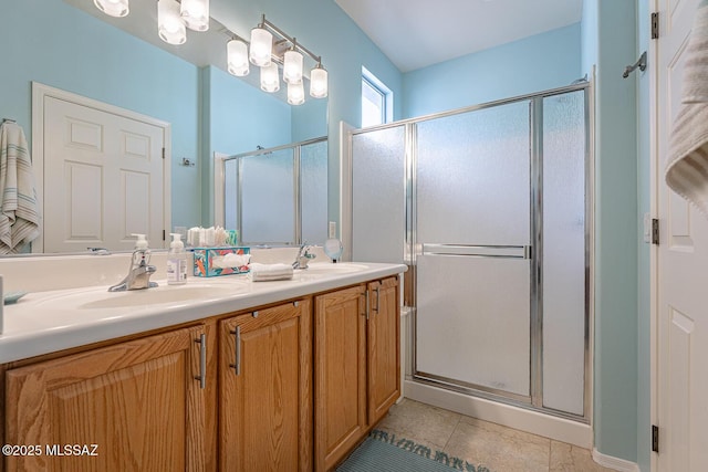 bathroom featuring tile patterned floors, vanity, and a shower with door