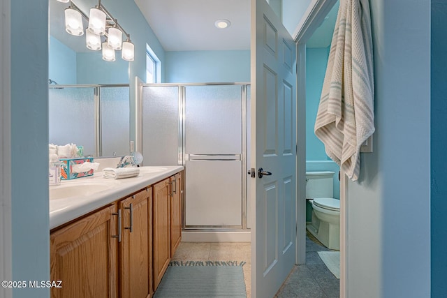 bathroom with tile patterned floors, vanity, toilet, and an enclosed shower