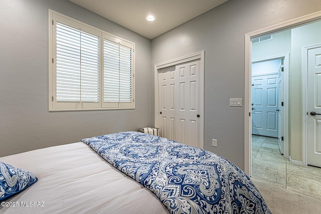 bedroom with a closet and light tile patterned floors