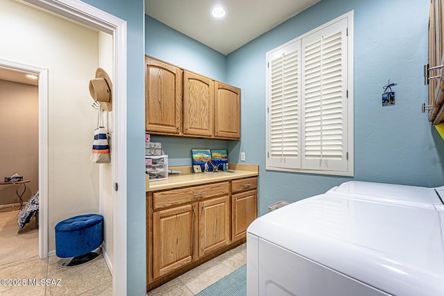 laundry area featuring cabinets and independent washer and dryer