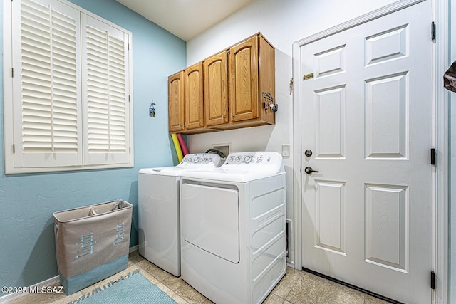 laundry area featuring cabinets and washing machine and clothes dryer