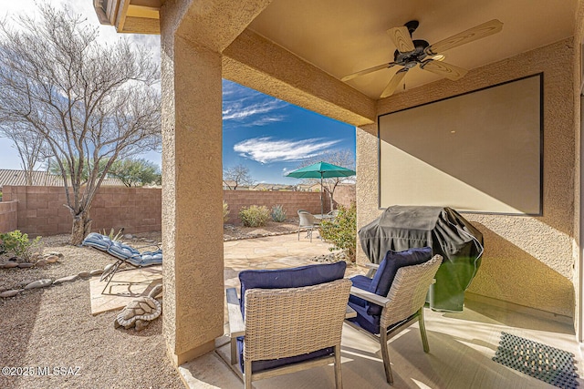 view of patio featuring area for grilling and ceiling fan