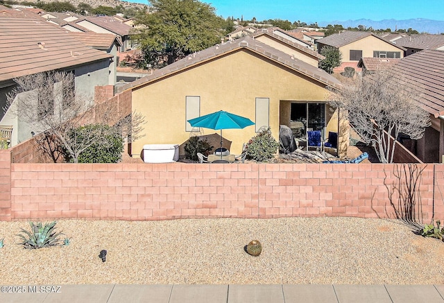 view of side of property featuring a mountain view and a patio area