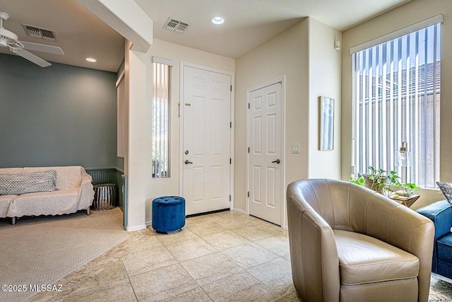 entryway with a wealth of natural light and ceiling fan